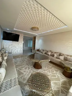 a living room with a couch and a table at إقامة الرياض الأطلس in Beni Mellal