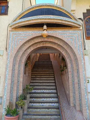 a staircase leading up to a building with a stair case at Riad La Belle Vue in Boumalne