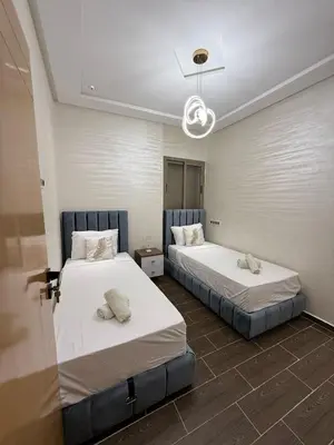 two beds in a room with at Kamlia meknes in Meknès