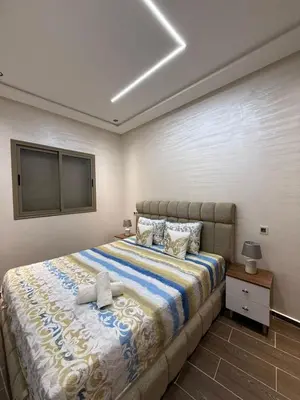 a bedroom with a large bed in a room at Kamlia meknes in Meknès