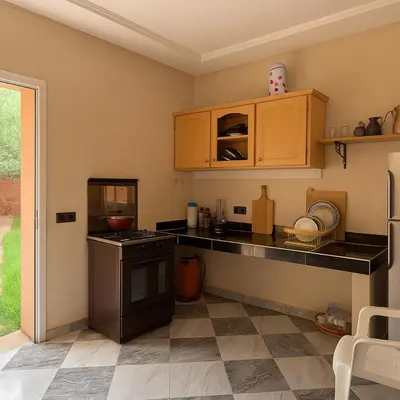 a kitchen with a stove and a counter top at Villa d'Exception à Ourika Nichée au Cœur des Montagnes in Aghbalou