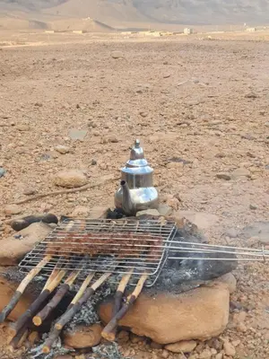 a grill in the middle of the desert at Dar lamane in Tamnougalt