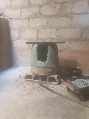 a brick oven in a room with a brick wall at Dar lamane in Tamnougalt