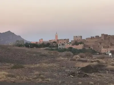 a town in the middle of a desert with buildings at Dar lamane in Tamnougalt