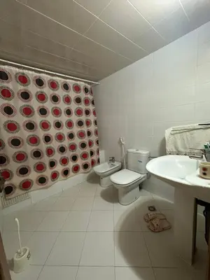 a white bathroom with a toilet and a sink at Mama Zakia Apartment in Fès