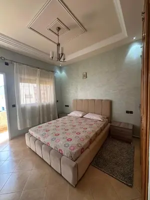 a bedroom with a large bed in a room at Mama Zakia Apartment in Fès
