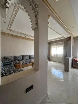 a living room with a couch and a mirror at Mama Zakia Apartment in Fès