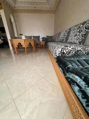 a living room with a couch and a table at Mama Zakia Apartment in Fès