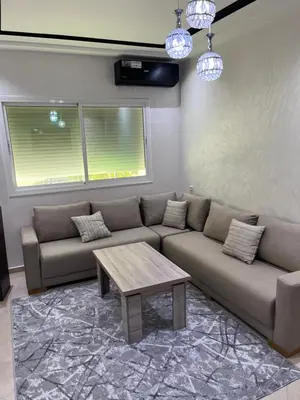 a living room with a couch and a coffee table at appartement fes in Fès