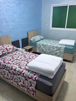 a bedroom with two twin beds and a window at appartement fes in Fès