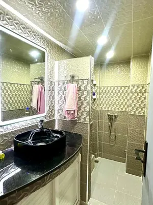 a bathroom with a black sink and a shower at Appartement pour les familles in Fès