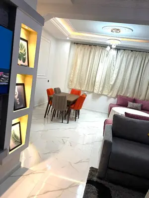 a living room with a table and a couch at Appartement pour les familles in Fès