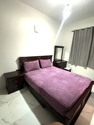 a bedroom with a purple bed with a purple blanket at Appartement pour les familles in Fès
