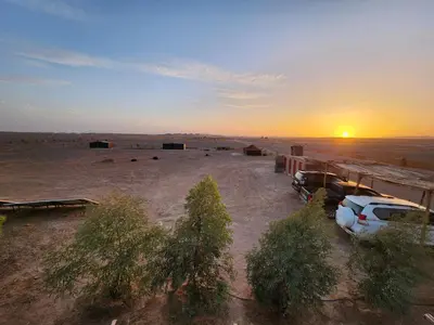 an aerial view of a parking lot in a desert at Camping Meteorite in Merzane