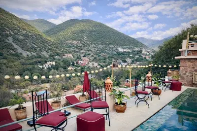 a patio with chairs and a view of the mountains at villa lalla Ourika & heated pool in Oulad Akkou