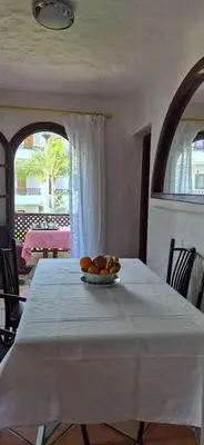 a table with a plate of fruit on top of it at Chez Nour in Oulad Akkou