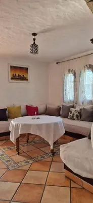 a living room with a couch and a table at Chez Nour in Oulad Akkou