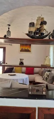 a room with a bed and a boat on the wall at Chez Nour in Oulad Akkou