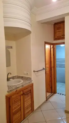 a bathroom with a sink and a mirror at New apartment fully equipped in Fès