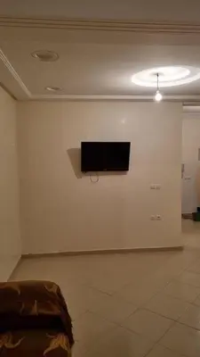 a room with a flat screen tv on a wall at New apartment fully equipped in Fès