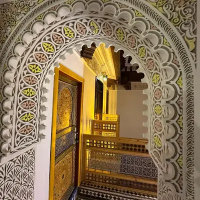 an archway with a door in a building at Riad Dar ElBellar in Fès