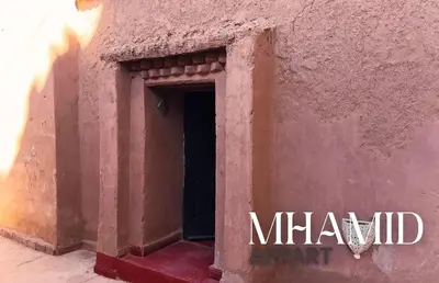 a door in the side of a building at mhamid hotel in Kasr Bounou
