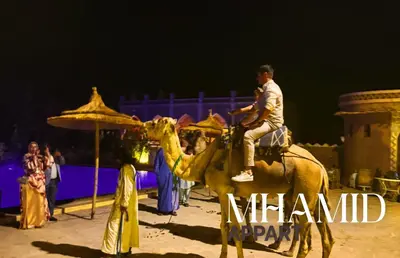 a man riding on a camel in a show at mhamid hotel in Kasr Bounou