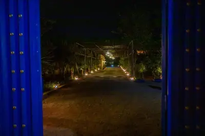 an empty road at night with lights on it at Domaine avec gouvernante 5 chambres, piscine, hamam et ferme pédagogique sur un hectare in Had Abdallah Rhiat