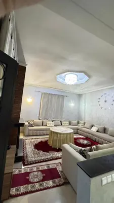 a living room with couches and a table at Villa bnssasi in Marrakech