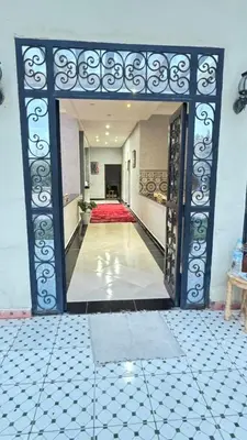 a hallway with an open door to a room at Villa bnssasi in Marrakech