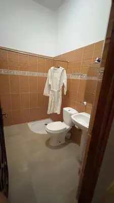 a bathroom with a toilet and a sink at Villa bnssasi in Marrakech