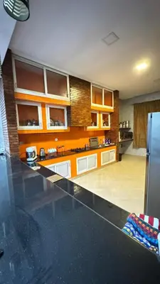 a kitchen with a black counter top and a refrigerator at Villa bnssasi in Marrakech