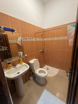 a bathroom with a toilet and a sink at Villa bnssasi in Marrakech
