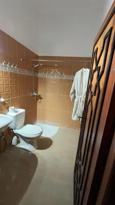 a bathroom with a toilet and a sink at Villa bnssasi in Marrakech