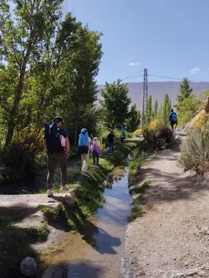 a group of people walking down a dirt trail at Auberge Palacio Sidi Hamza in Tazrouft