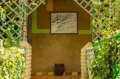 a painting on the side of a wall with a vase at Auberge Palacio Sidi Hamza in Tazrouft