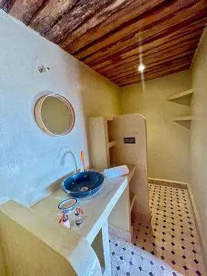a bathroom with a sink in a room at Dar Zitoune - Authentic Stay in Tagounite in Tagounite