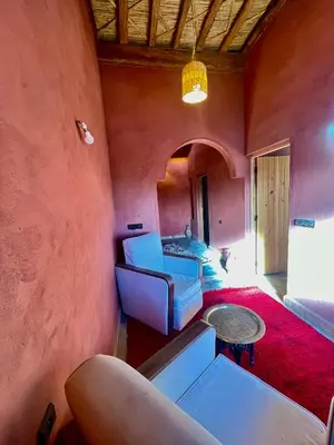 a living room with a couch and a table at Dar Zitoune - Authentic Stay in Tagounite in Tagounite