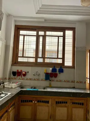 a kitchen with a sink and two windows in it at Large 3 Bedrooms Medina center Parking Secure in Fès