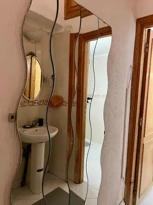 a bathroom with a sink and a mirror at Large 3 Bedrooms Medina center Parking Secure in Fès