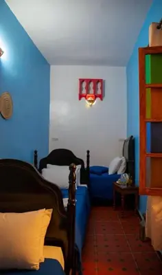 a blue room with a bed and a couch at Riad misk lile fez in Fès