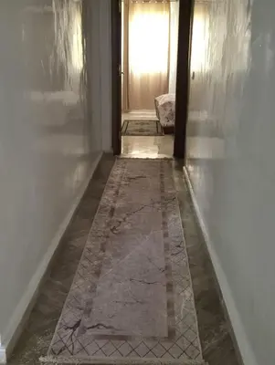a hallway with a tile floor and a window at Luxury Apartment in Fes City Centre for Families in Fès