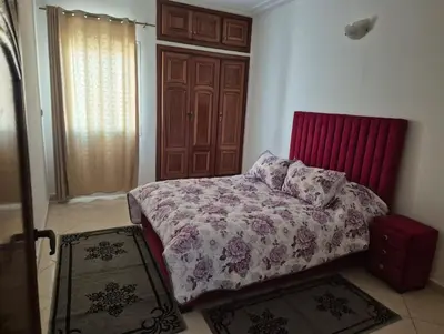 a bedroom with a bed with a red head board at Luxury Apartment in Fes City Centre for Families in Fès
