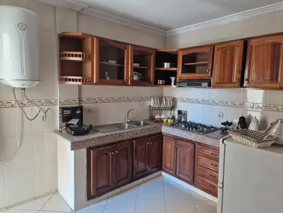a kitchen with wooden cabinets and a sink at Luxury Apartment in Fes City Centre for Families in Fès