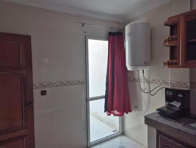 a bathroom with a window and a red curtain at Luxury Apartment in Fes City Centre for Families in Fès
