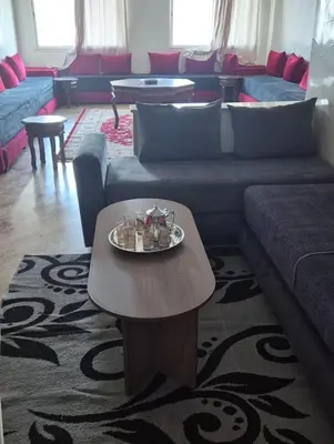 a living room with a couch and a table at Luxury Apartment in Fes City Centre for Families in Fès