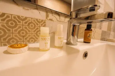 a bathroom sink with bottles ofodorizers sitting on it at Relax Family 12 - Cozy Entire Apartment in City Center in Ouarzazate