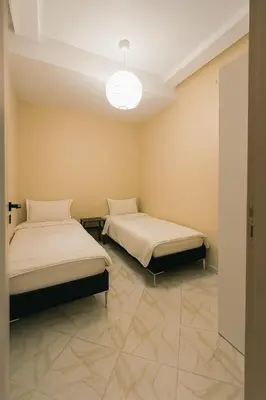 a room with two beds and a light at Relax Family 12 - Cozy Entire Apartment in City Center in Ouarzazate