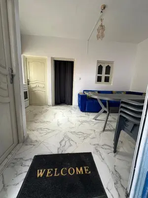 aoyer with a welcome mat on a marble floor at A unique and cute apartment in a prime location in Er Rachidia