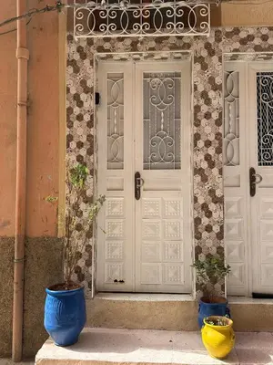 two blue vases sitting in front of a door at A unique and cute apartment in a prime location in Er Rachidia